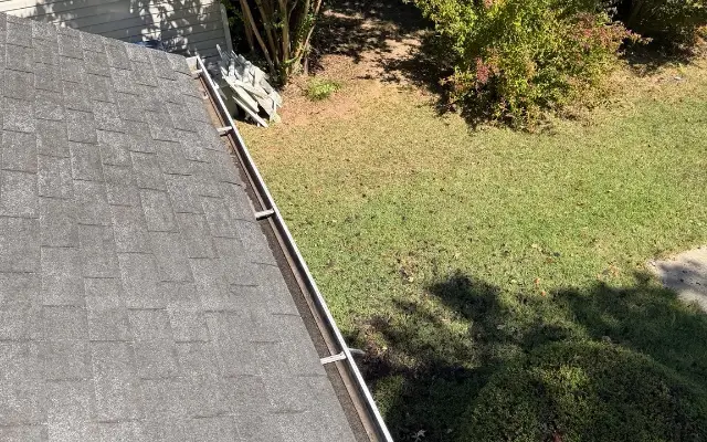 The same gutter at a Winder home visibly cleared after cleaning