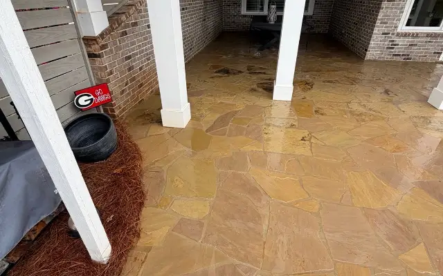 Covered flagstone patio in Statham after cleaning with the stone still wet