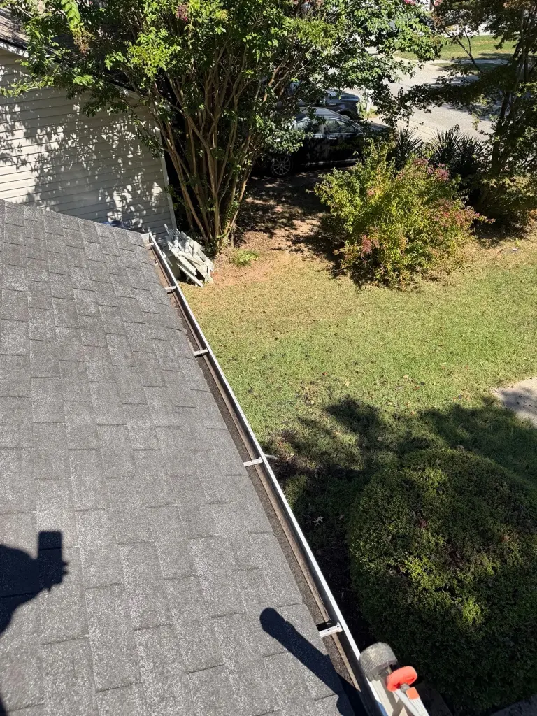 The same gutter at a Winder home visibly cleared after cleaning