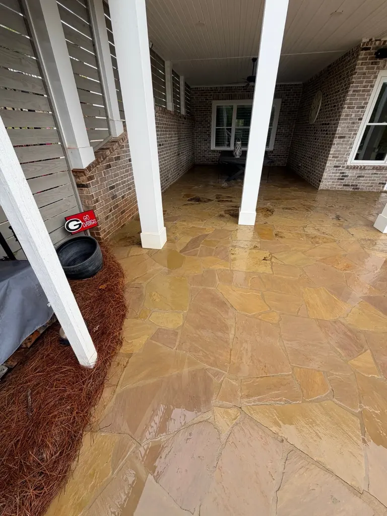 Covered flagstone patio in Statham after cleaning with the stone still wet