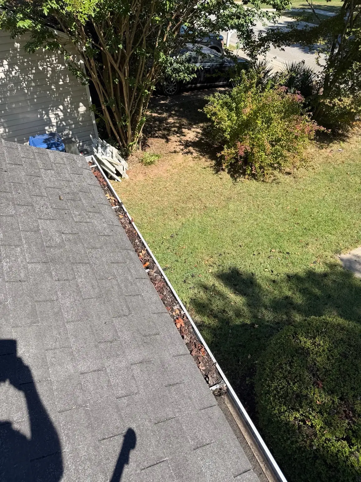 Gutter at a Winder home filled with leaves and debris before cleaning