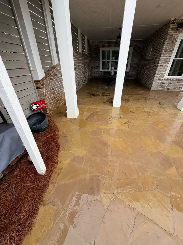 Covered flagstone patio in Statham after cleaning with the stone still wet