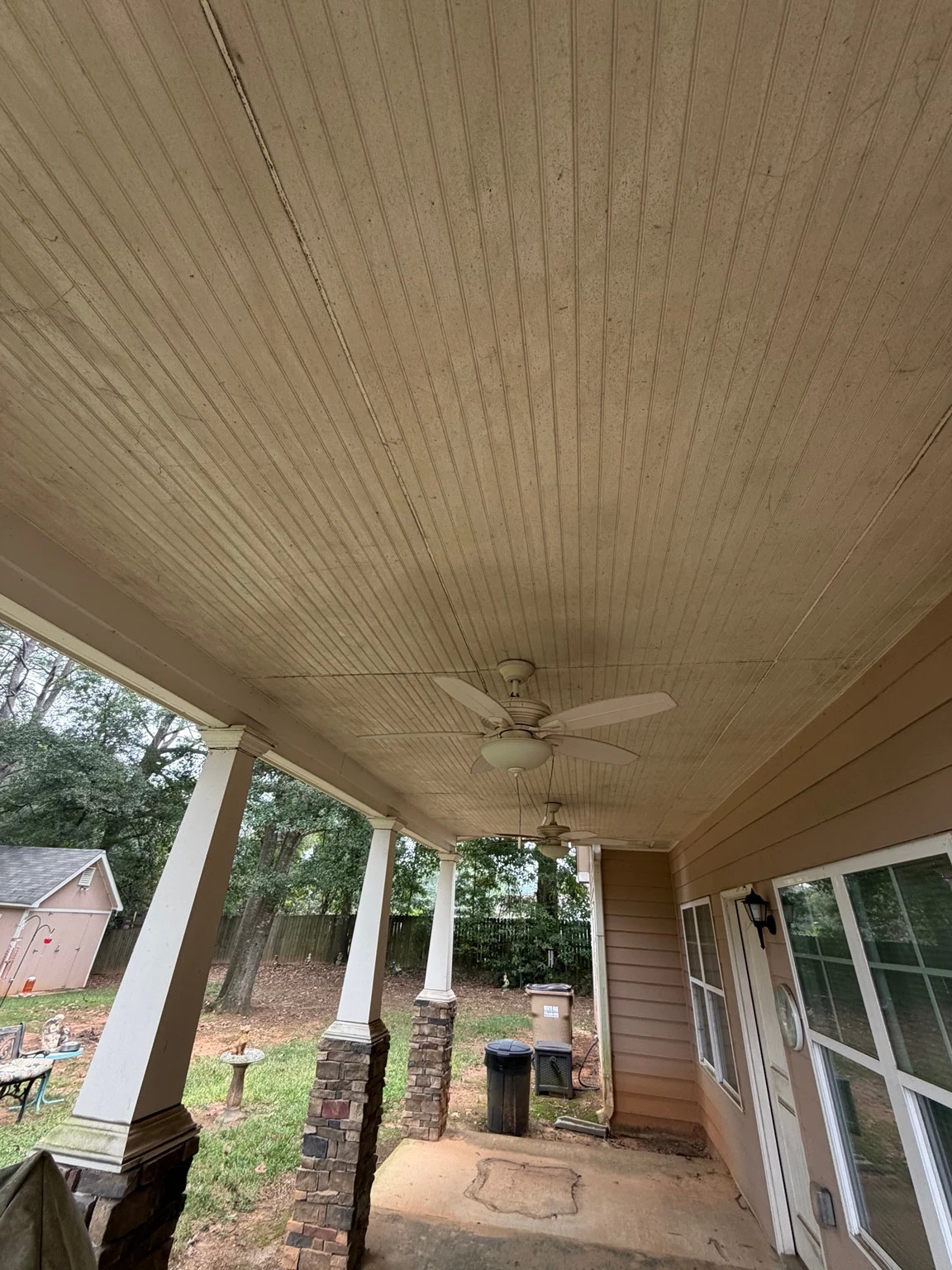 Covered porch ceiling in Auburn with visible dirt and buildup before softwashing