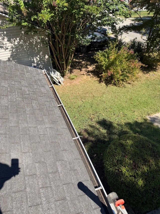 The same gutter at a Winder home visibly cleared after cleaning